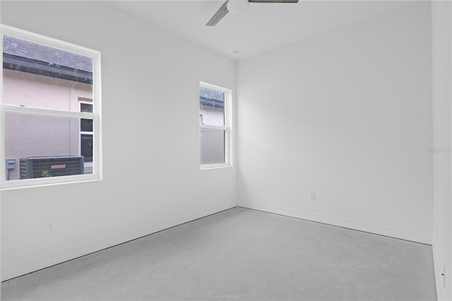 spare room featuring ceiling fan and a wealth of natural light