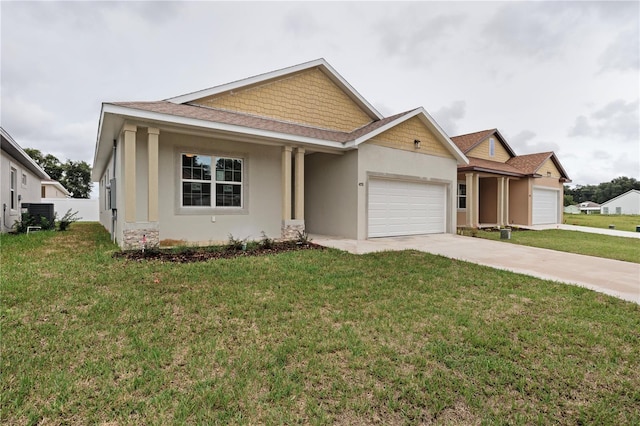 view of front of house with a front lawn, a garage, and central AC