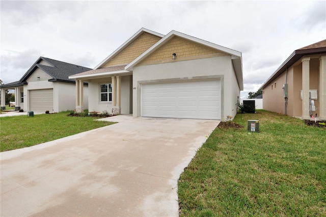 view of front of house with a garage, a front yard, and central AC unit