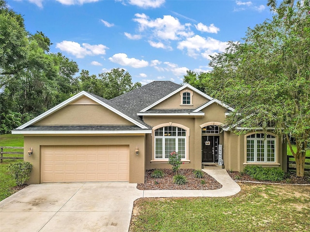 view of front facade with a garage and a front lawn