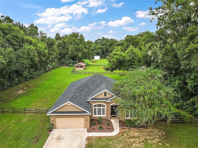 exterior space featuring a garage and a front lawn