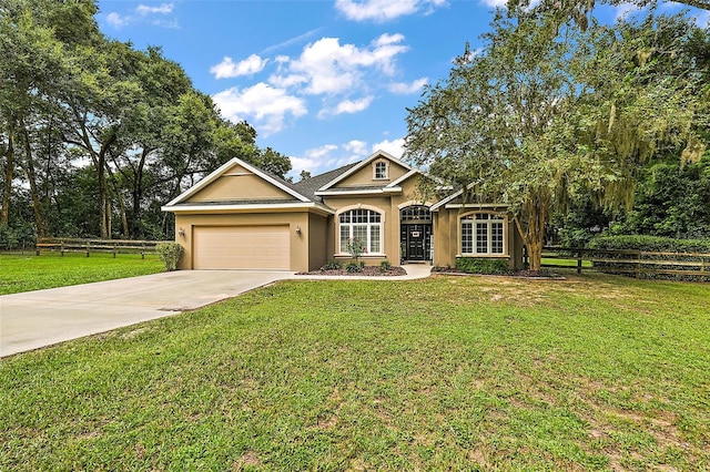 view of front of property featuring a front lawn and a garage