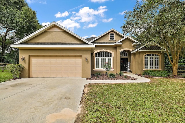 view of front facade with a front lawn and a garage