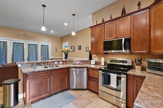 kitchen with pendant lighting, light tile patterned floors, stainless steel appliances, sink, and kitchen peninsula