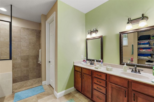 bathroom featuring vanity, a tile shower, and tile patterned floors