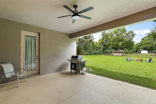 view of patio featuring ceiling fan and a grill