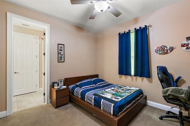 carpeted bedroom with a textured ceiling and ceiling fan