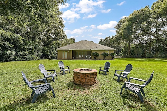 view of yard with a fire pit