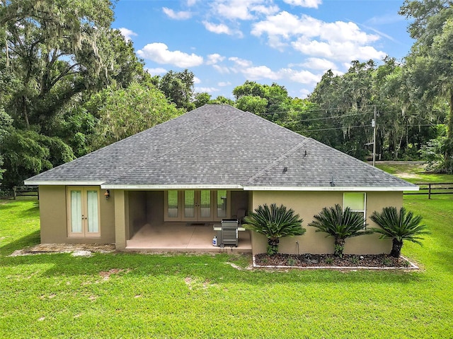 back of house with a patio area and a yard