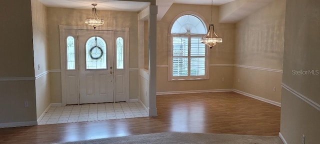 foyer with a chandelier and light wood-type flooring