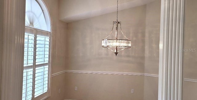 interior details featuring a chandelier