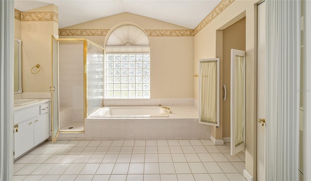 bathroom with tile patterned floors, vanity, separate shower and tub, and lofted ceiling