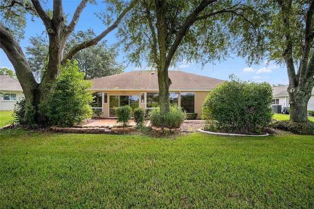 single story home with central AC unit and a front lawn