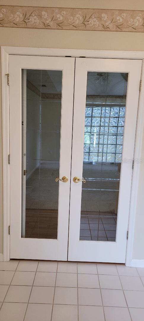 interior space featuring french doors and light tile patterned floors