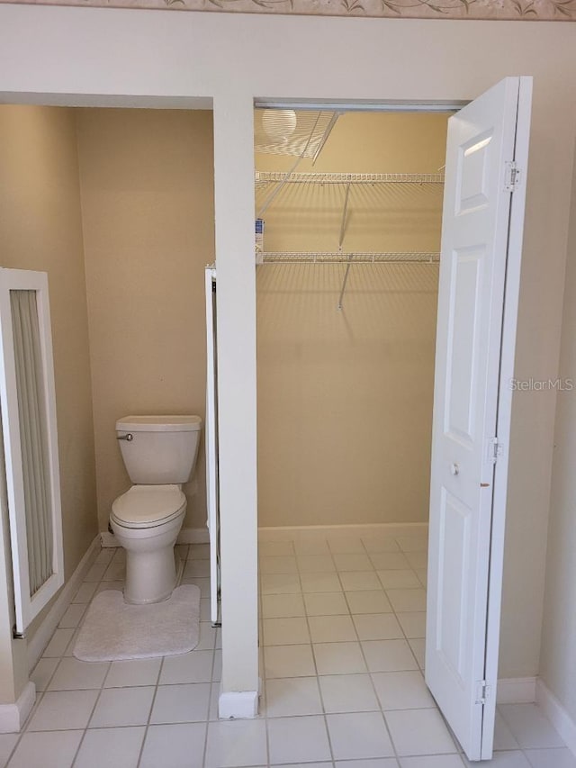 bathroom featuring tile patterned flooring and toilet