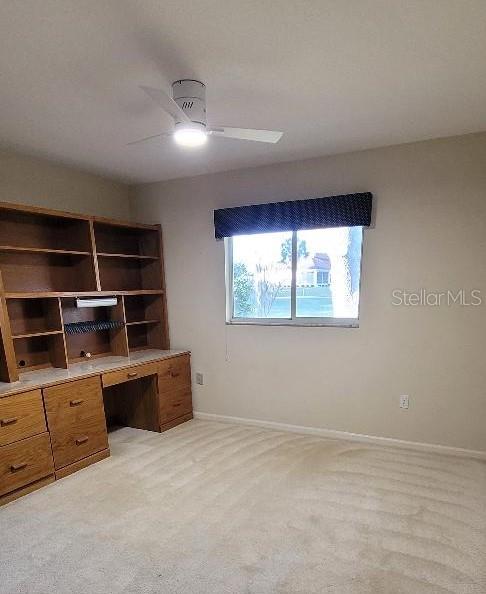 unfurnished office with light carpet and ceiling fan