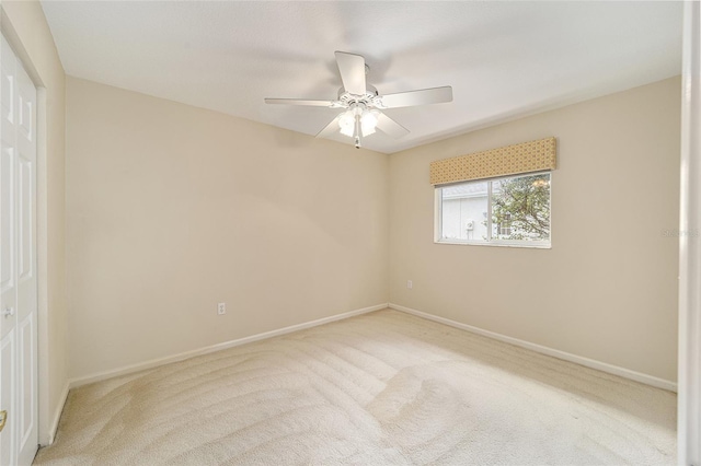 unfurnished room featuring light carpet and ceiling fan