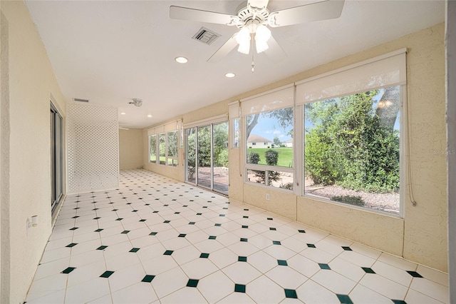 sunroom / solarium with ceiling fan and plenty of natural light