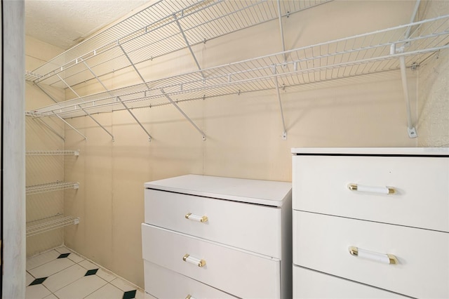 spacious closet featuring tile patterned flooring