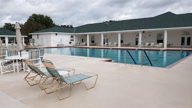 view of swimming pool featuring a patio area and ceiling fan