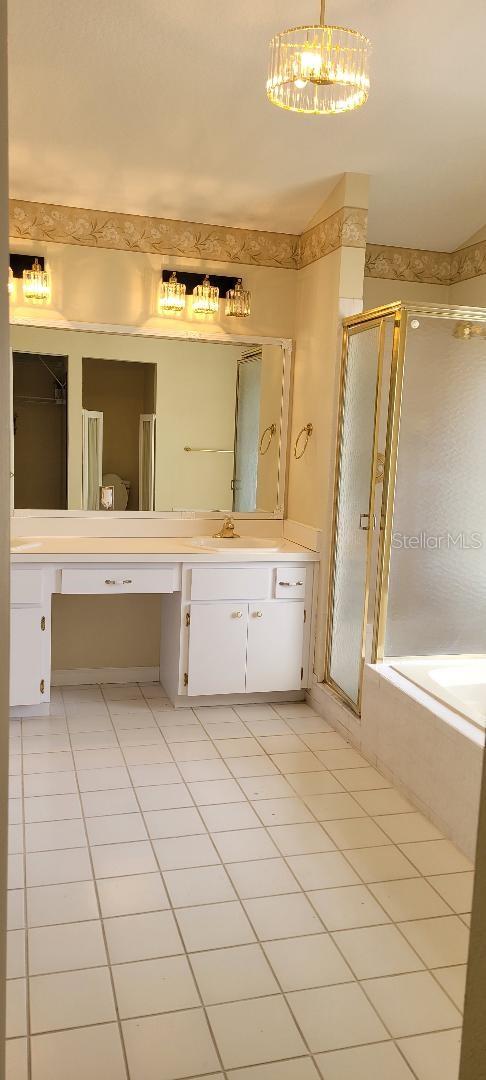 bathroom featuring vanity, tile patterned floors, and independent shower and bath