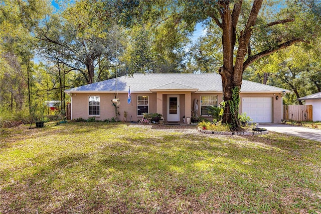 ranch-style home featuring a garage and a front lawn