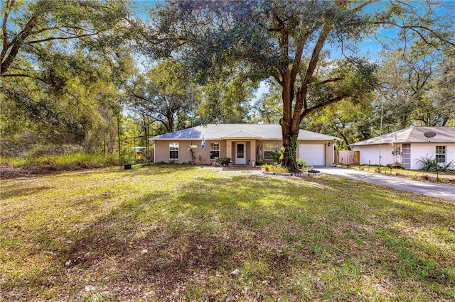 ranch-style home with a garage and a front yard