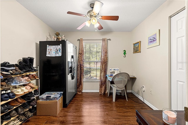 office area with ceiling fan, dark hardwood / wood-style floors, and a textured ceiling