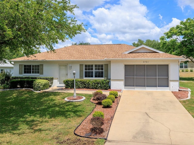 ranch-style home with a front lawn and a garage