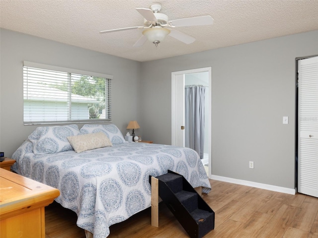 bedroom with light wood-type flooring, a closet, ceiling fan, and a textured ceiling