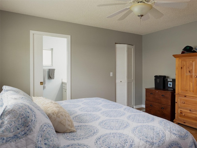 bedroom featuring ensuite bathroom, a closet, wood-type flooring, ceiling fan, and a textured ceiling