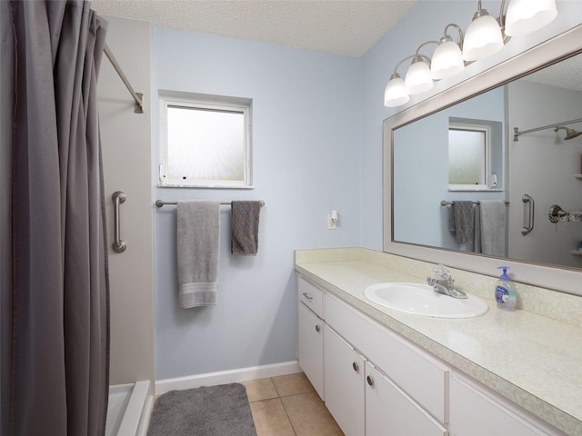 bathroom featuring a textured ceiling, vanity, and a shower with curtain