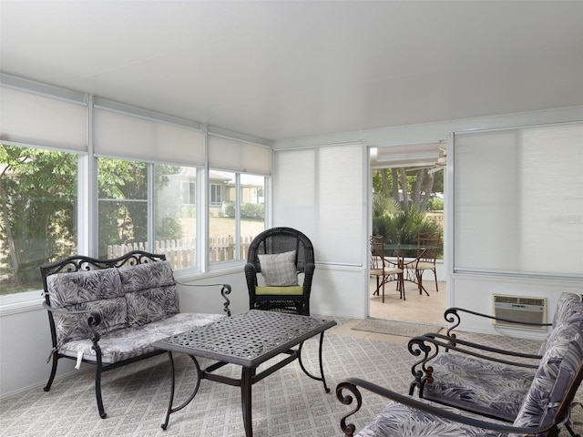 sunroom featuring a wall mounted AC and a wealth of natural light