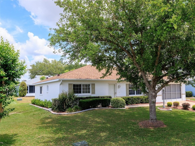 ranch-style home featuring a garage and a front yard