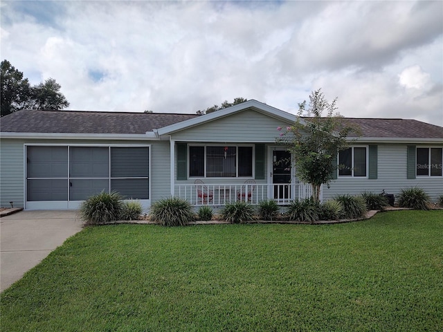 ranch-style home featuring a shingled roof, concrete driveway, a front yard, covered porch, and a garage