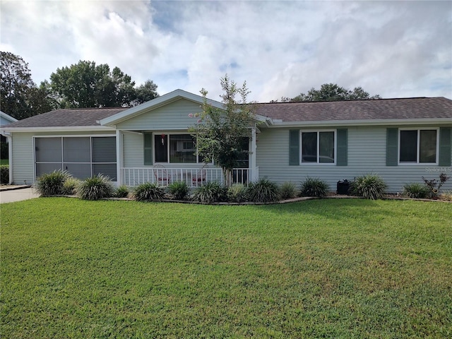 single story home featuring a garage, covered porch, a front yard, and roof with shingles