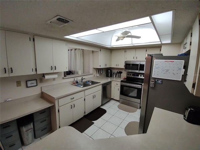 kitchen featuring visible vents, a sink, appliances with stainless steel finishes, light tile patterned flooring, and light countertops