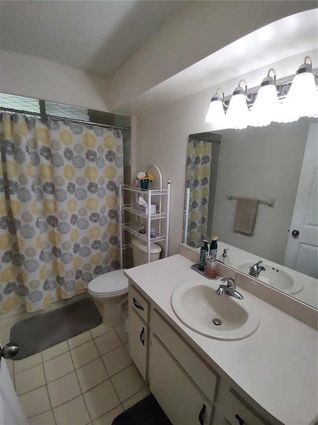 bathroom with tile patterned floors, a shower with shower curtain, toilet, and vanity