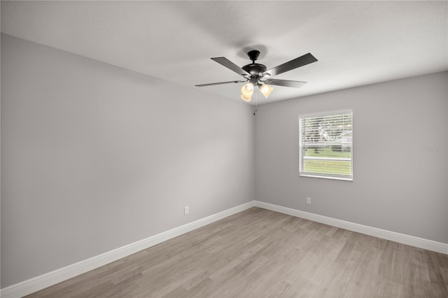 empty room with ceiling fan and light wood-type flooring