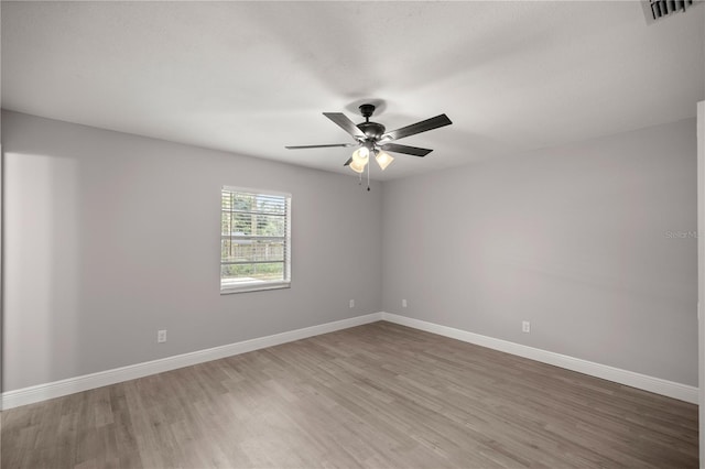 spare room with hardwood / wood-style floors and ceiling fan