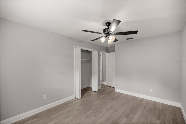 unfurnished bedroom with ceiling fan, light hardwood / wood-style floors, and a closet