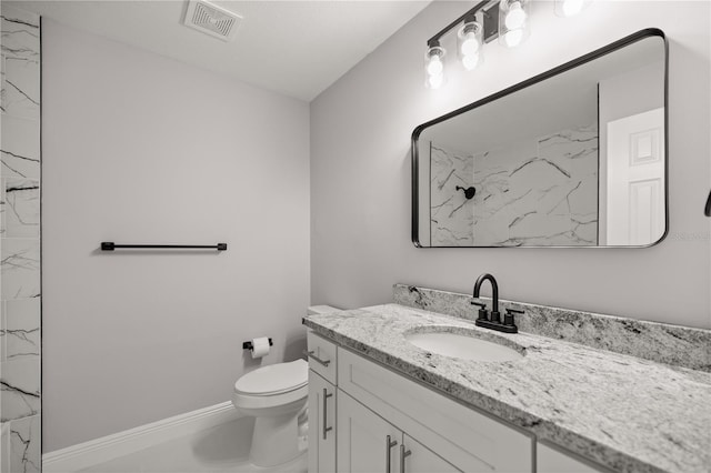 bathroom with vanity, toilet, and walk in shower