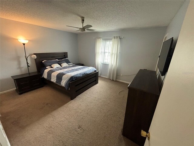 carpeted bedroom with a textured ceiling and ceiling fan