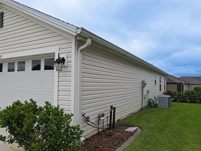 view of property exterior featuring a yard and central AC