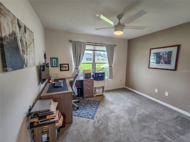 carpeted office space featuring a textured ceiling and ceiling fan