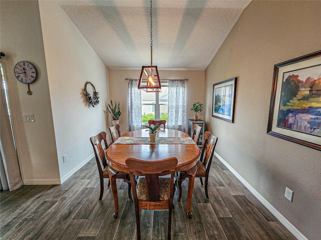 dining space with a textured ceiling, vaulted ceiling, and dark wood-type flooring