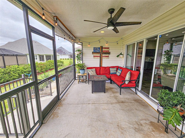 unfurnished sunroom featuring ceiling fan