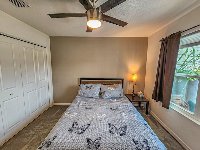 bedroom with ceiling fan, a closet, and a textured ceiling