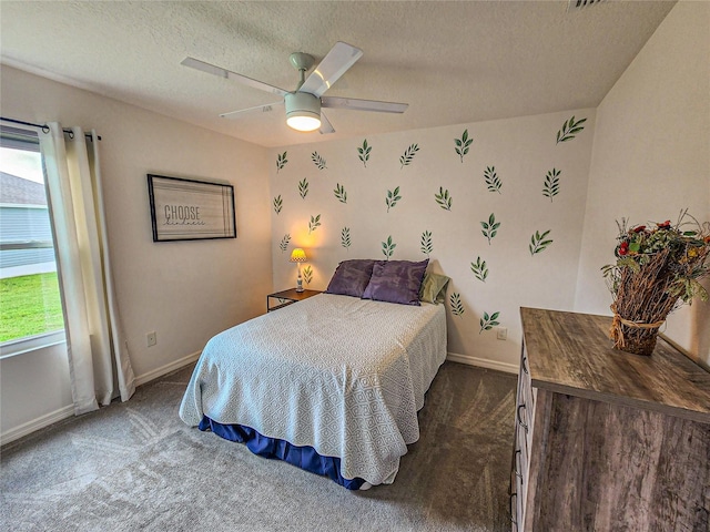 carpeted bedroom featuring a textured ceiling and ceiling fan