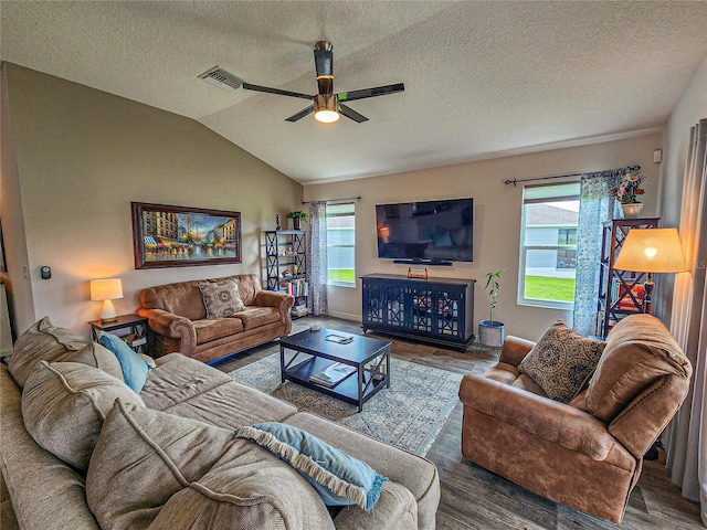 living room featuring hardwood / wood-style flooring, a wealth of natural light, and vaulted ceiling